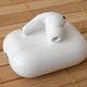 The right Apple AirPods Pro 2nd Generation earbud sitting atop the closed charging case.